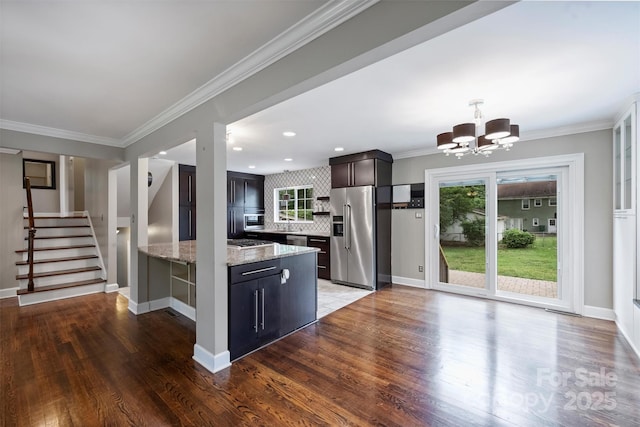 7050 Knightswood Dr, Charlotte, NC 28226 - kitchen featuring high end fridge, a chandelier, wood finished floors, tasteful backsplash, and ornamental molding