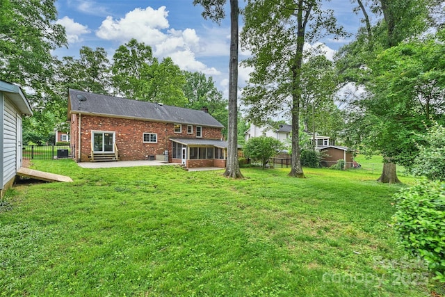 7050 Knightswood Dr, Charlotte, NC 28226 - back of house featuring brick siding, a patio, a sunroom, entry steps, and a chimney