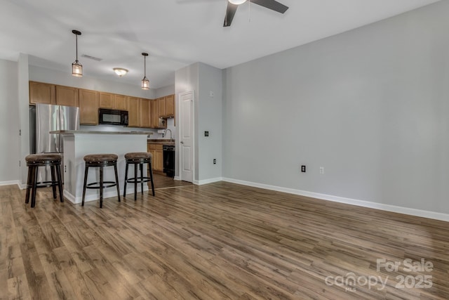 176 Brickton Village Cir Unit 302, Fletcher, NC 28732 - kitchen with black microwave, ceiling fan, wood finished floors, and baseboards