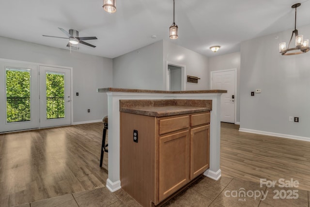 176 Brickton Village Cir Unit 302, Fletcher, NC 28732 - kitchen featuring baseboards, a ceiling fan, dark countertops, and dark wood-type flooring