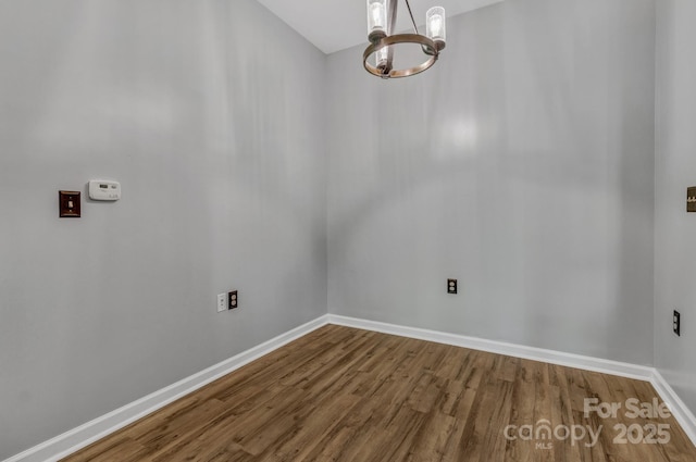 176 Brickton Village Cir Unit 302, Fletcher, NC 28732 - spare room featuring a chandelier, wood finished floors, and baseboards