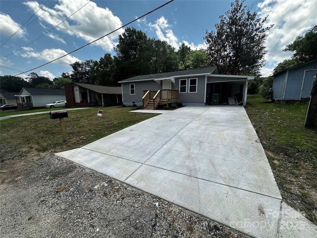 801 Calhoun St, Lancaster, SC 29720 - view of front facade with concrete driveway, a front yard, and an attached carport