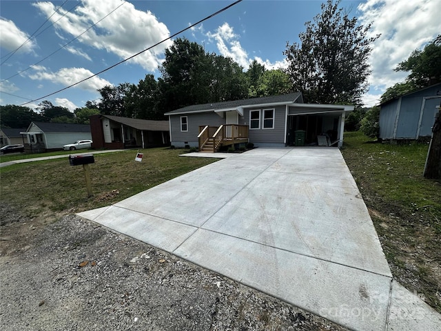 801 Calhoun St, Lancaster, SC 29720 - view of front facade with concrete driveway, a front yard, and an attached carport