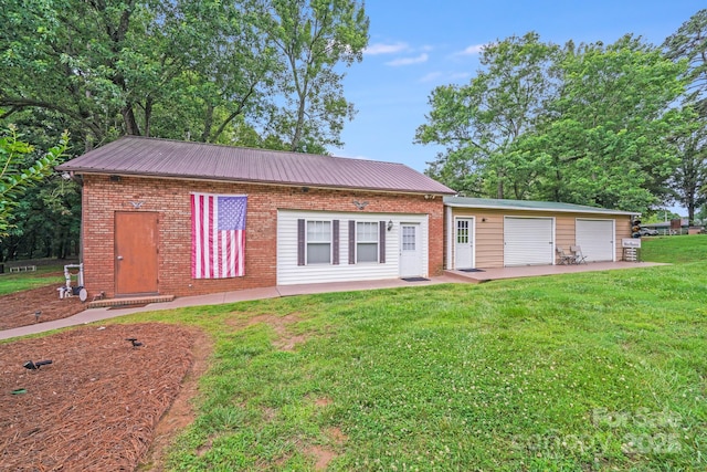 211 Drive Inn Rd, Locust, NC 28097 - rear view of property with a yard, metal roof, and brick siding
