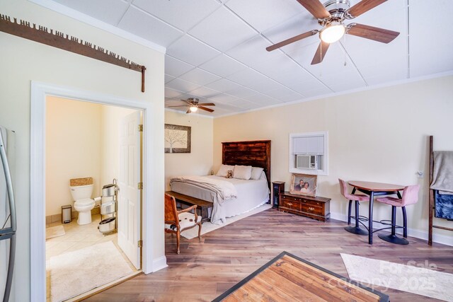 211 Drive Inn Rd, Locust, NC 28097 - bedroom featuring wood finished floors, baseboards, and connected bathroom