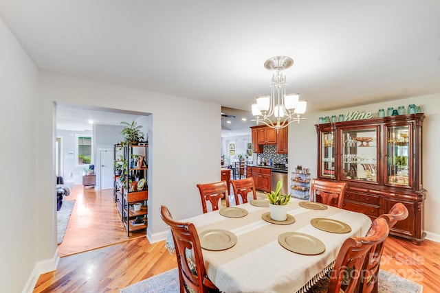 211 Drive Inn Rd, Locust, NC 28097 - dining room with a chandelier, light wood finished floors, and baseboards