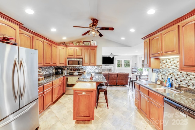 211 Drive Inn Rd, Locust, NC 28097 - kitchen with appliances with stainless steel finishes, ceiling fan, lofted ceiling, a kitchen breakfast bar, and a sink