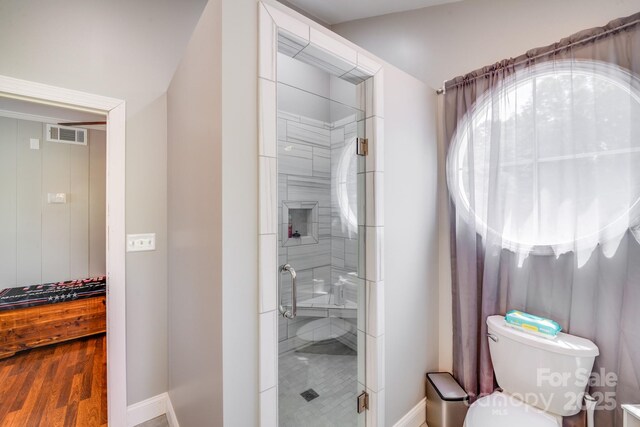 211 Drive Inn Rd, Locust, NC 28097 - full bathroom with a stall shower, toilet, baseboards, and wood finished floors