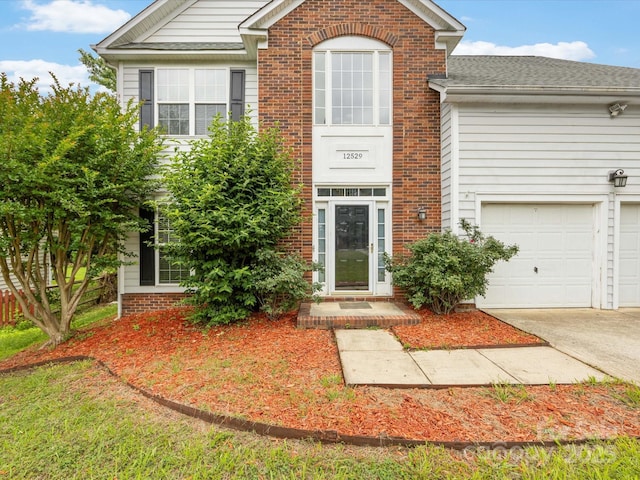 12529 Old Timber Rd, Charlotte, NC 28269 - traditional-style house with brick siding, concrete driveway, and an attached garage