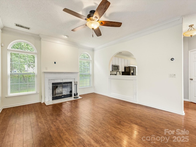 12529 Old Timber Rd, Charlotte, NC 28269 - unfurnished living room with crown molding, ceiling fan, hardwood / wood-style flooring, a fireplace, and plenty of natural light