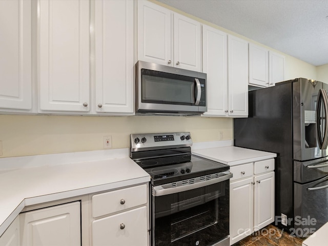 12529 Old Timber Rd, Charlotte, NC 28269 - kitchen featuring stainless steel appliances, white cabinetry, and light countertops