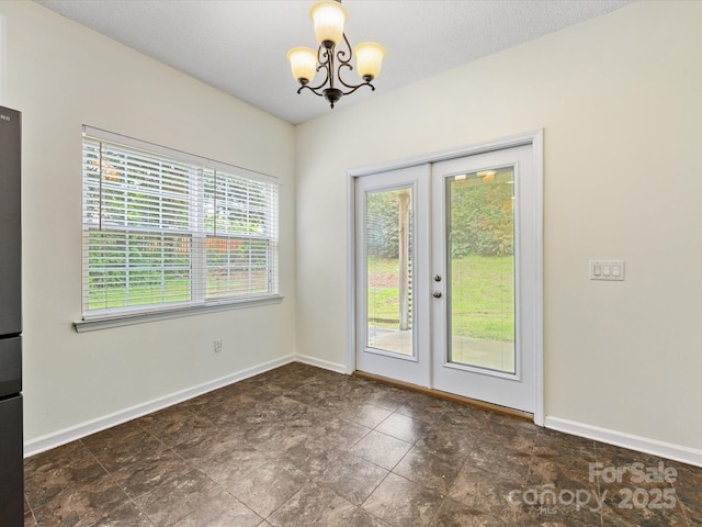 12529 Old Timber Rd, Charlotte, NC 28269 - unfurnished dining area featuring a chandelier, baseboards, and french doors