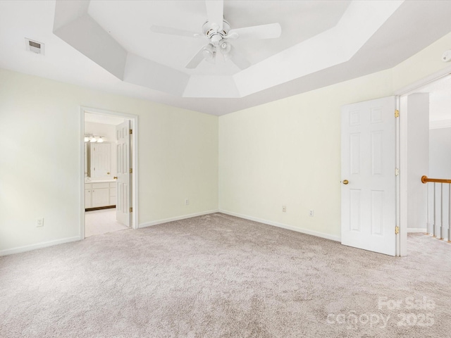 12529 Old Timber Rd, Charlotte, NC 28269 - unfurnished bedroom with a tray ceiling, carpet floors, baseboards, and connected bathroom
