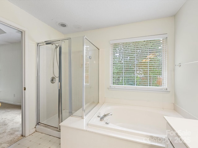 12529 Old Timber Rd, Charlotte, NC 28269 - full bathroom featuring a shower stall, a garden tub, vanity, and a textured ceiling