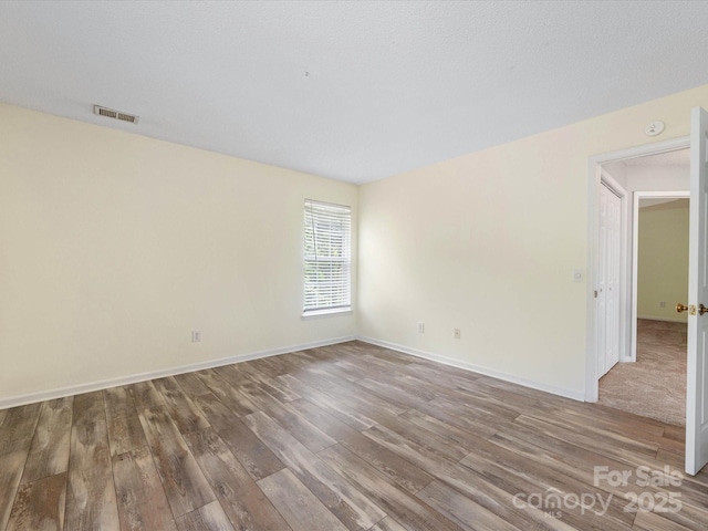 12529 Old Timber Rd, Charlotte, NC 28269 - empty room featuring wood finished floors, baseboards, and a smoke detector