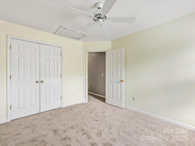 12529 Old Timber Rd, Charlotte, NC 28269 - unfurnished bedroom with carpet, a closet, a textured ceiling, baseboards, and attic access