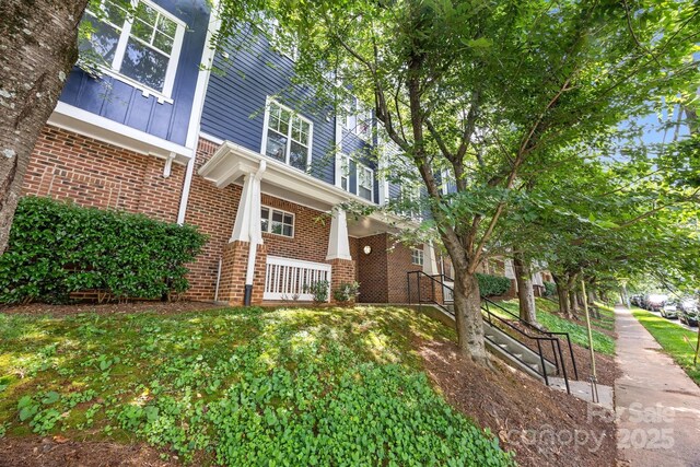 1556 Walnut View Dr, Charlotte, NC 28208 - view of side of home with brick siding and a porch