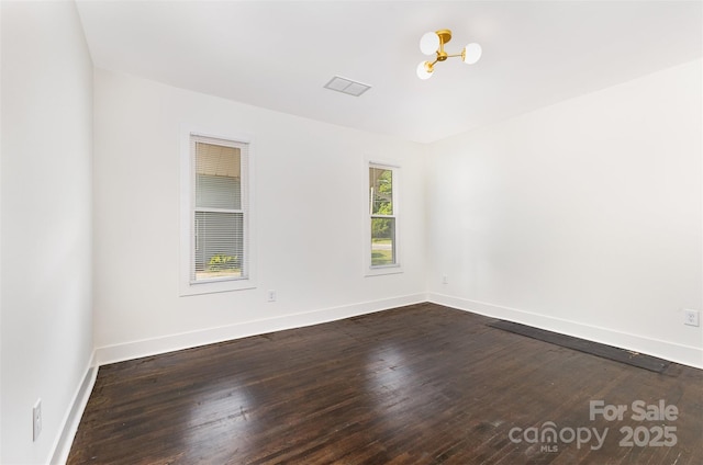 1112 Concord Ave, Monroe, NC 28110 - empty room with dark wood-style floors, baseboards, and a chandelier