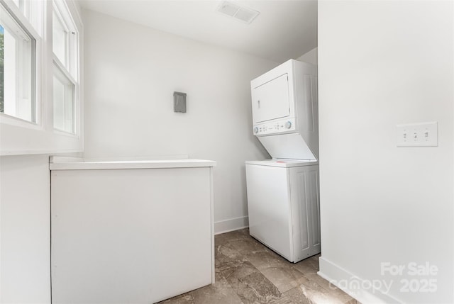 1112 Concord Ave, Monroe, NC 28110 - washroom featuring stacked washer and clothes dryer and baseboards