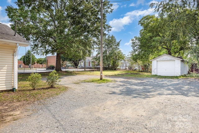1112 Concord Ave, Monroe, NC 28110 - view of yard featuring a detached garage, an outdoor structure, and driveway