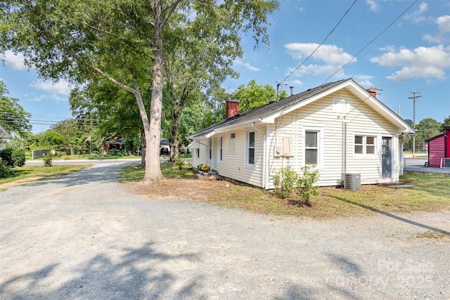 1112 Concord Ave, Monroe, NC 28110 - view of property exterior featuring a chimney and central AC