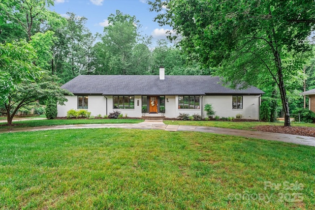 625 S Magnolia St, Mooresville, NC 28115 - ranch-style house featuring a chimney, a front lawn, and concrete driveway