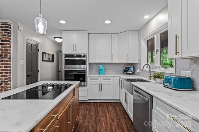 625 S Magnolia St, Mooresville, NC 28115 - kitchen with appliances with stainless steel finishes, white cabinets, dark wood-style floors, a sink, and light stone countertops