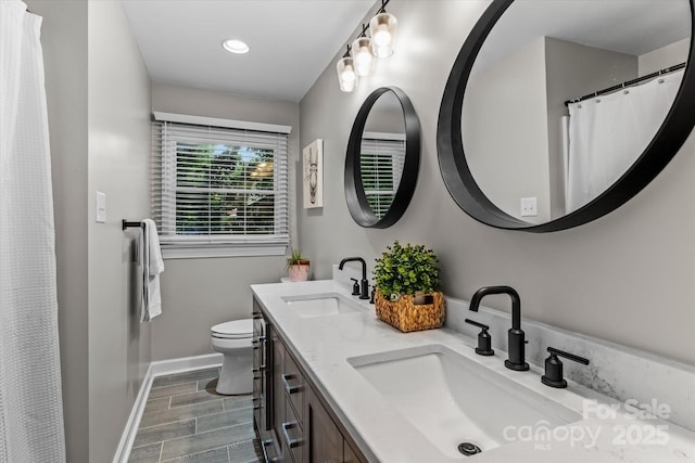 625 S Magnolia St, Mooresville, NC 28115 - full bath featuring baseboards, toilet, double vanity, wood finished floors, and recessed lighting