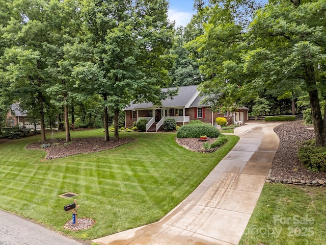 635 Timberlane Trl, Salisbury, NC 28147 - ranch-style house featuring brick siding, a front lawn, driveway, and roof with shingles