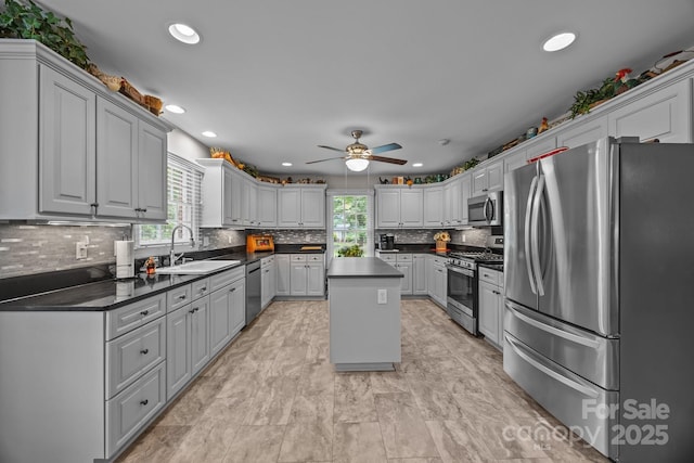 635 Timberlane Trl, Salisbury, NC 28147 - kitchen with stainless steel appliances, a sink, ceiling fan, dark countertops, and tasteful backsplash