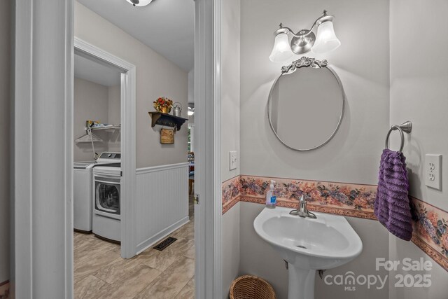 635 Timberlane Trl, Salisbury, NC 28147 - bathroom featuring wainscoting and washing machine and dryer