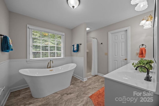 635 Timberlane Trl, Salisbury, NC 28147 - full bath featuring vanity, a freestanding tub, a shower with shower curtain, and baseboards