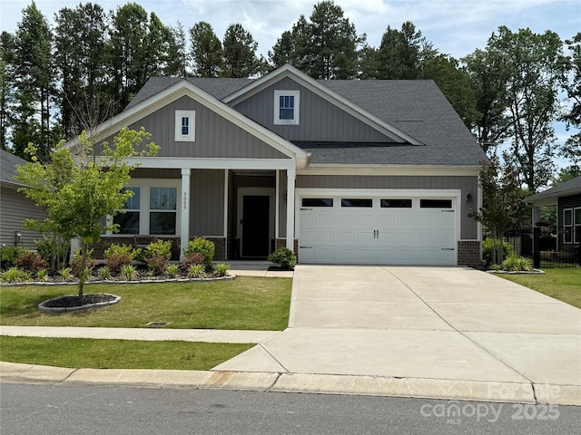 9009 Myrna Dr, Gastonia, NC 28056 - craftsman-style house featuring an attached garage, concrete driveway, a front yard, a shingled roof, and board and batten siding