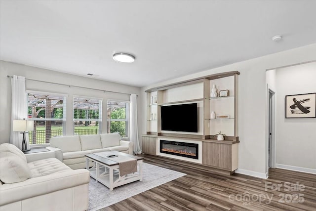 9009 Myrna Dr, Gastonia, NC 28056 - living room with dark wood-type flooring and a glass covered fireplace