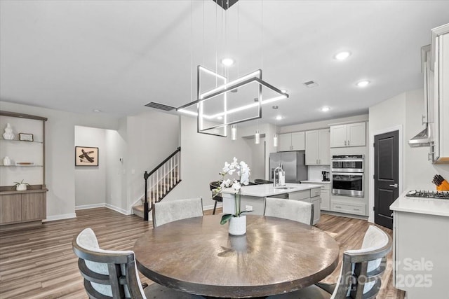 9009 Myrna Dr, Gastonia, NC 28056 - dining room featuring stairway, wood finished floors, and recessed lighting