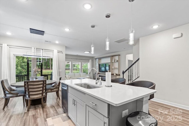 9009 Myrna Dr, Gastonia, NC 28056 - kitchen featuring light countertops, light wood finished floors, an island with sink, recessed lighting, and pendant lighting