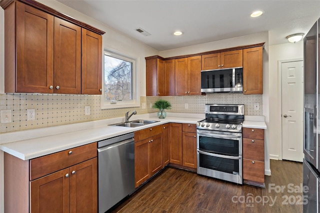 31 English Ivy Rd, Asheville, NC 28806 - kitchen with appliances with stainless steel finishes, dark wood-style flooring, a sink, decorative backsplash, and recessed lighting