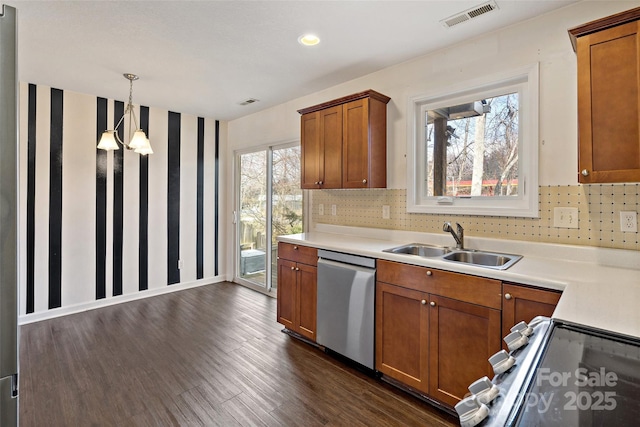 31 English Ivy Rd, Asheville, NC 28806 - kitchen with stainless steel dishwasher, a sink, dark wood-style flooring, range with electric cooktop, and brown cabinetry