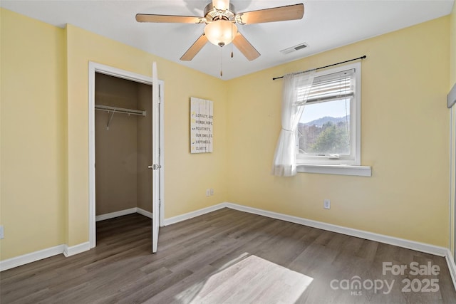 31 English Ivy Rd, Asheville, NC 28806 - unfurnished bedroom featuring wood finished floors, a closet, baseboards, and a ceiling fan