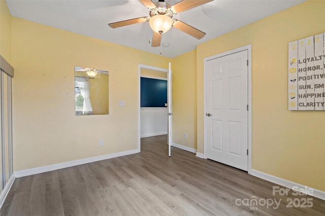 31 English Ivy Rd, Asheville, NC 28806 - unfurnished bedroom featuring wood finished floors, baseboards, and ceiling fan