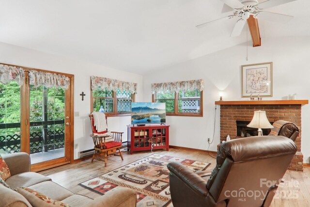 418 Stoney Ridge Loop, Maggie Valley, NC 28751 - living room with healthy amount of natural light, a baseboard radiator, and wood finished floors