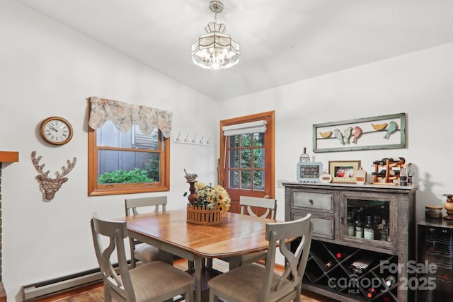 418 Stoney Ridge Loop, Maggie Valley, NC 28751 - dining room featuring a chandelier, a baseboard heating unit, and wood finished floors