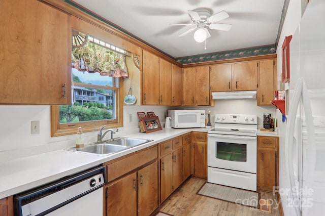 418 Stoney Ridge Loop, Maggie Valley, NC 28751 - kitchen with white appliances, under cabinet range hood, a sink, light countertops, and brown cabinetry