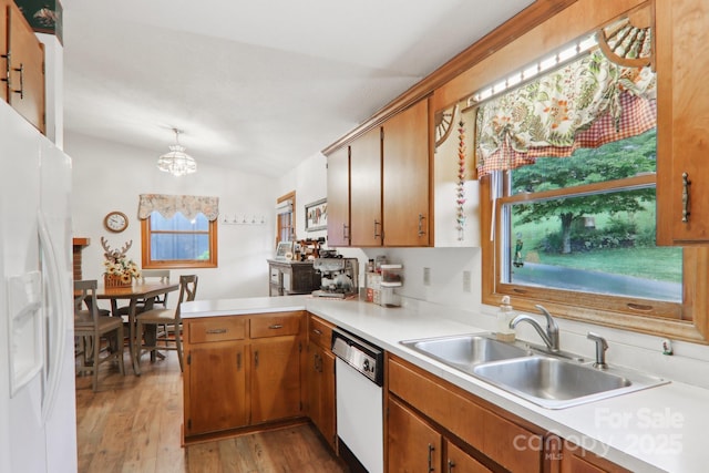 418 Stoney Ridge Loop, Maggie Valley, NC 28751 - kitchen with white appliances, a sink, light countertops, light wood-style floors, and a peninsula