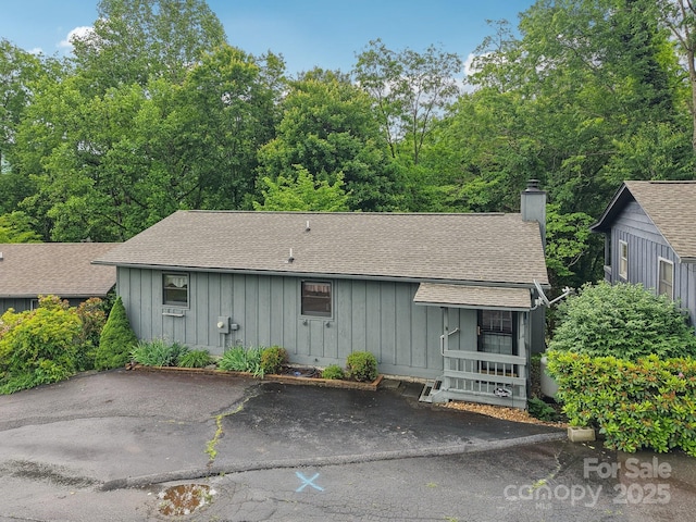 418 Stoney Ridge Loop, Maggie Valley, NC 28751 - view of front of property with board and batten siding, a chimney, and roof with shingles