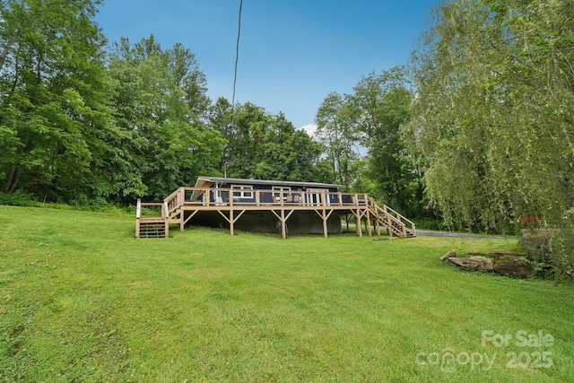 72 Wakulla Dr, Maggie Valley, NC 28751 - back of property with stairs, a wooden deck, and a lawn