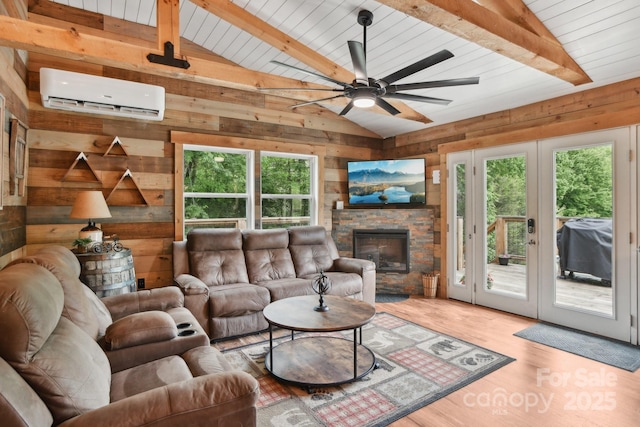 72 Wakulla Dr, Maggie Valley, NC 28751 - living room featuring a wall mounted air conditioner, healthy amount of natural light, wooden walls, a ceiling fan, and wood finished floors