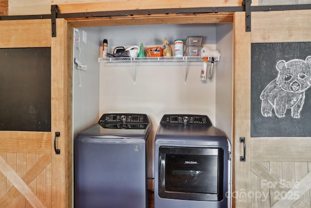 72 Wakulla Dr, Maggie Valley, NC 28751 - washroom with a barn door and washer and clothes dryer