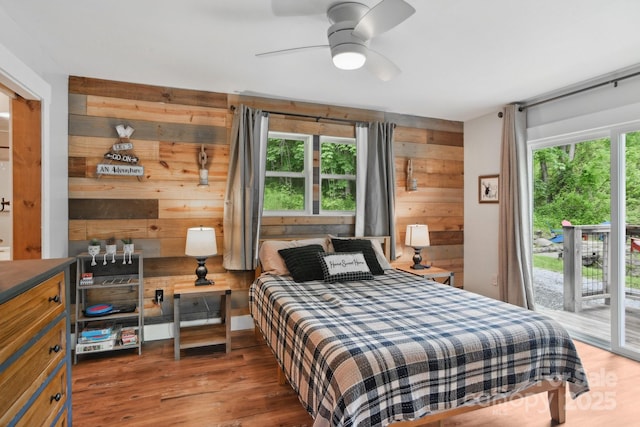 72 Wakulla Dr, Maggie Valley, NC 28751 - bedroom featuring wood walls, access to outside, wood finished floors, and a ceiling fan