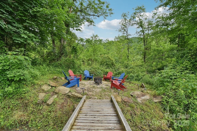 72 Wakulla Dr, Maggie Valley, NC 28751 - view of yard featuring an outdoor fire pit and a view of trees